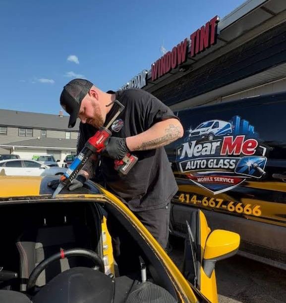 Near Me Auto Glass technician working on a windshield