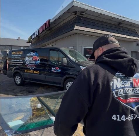 Technician sealing a windshield