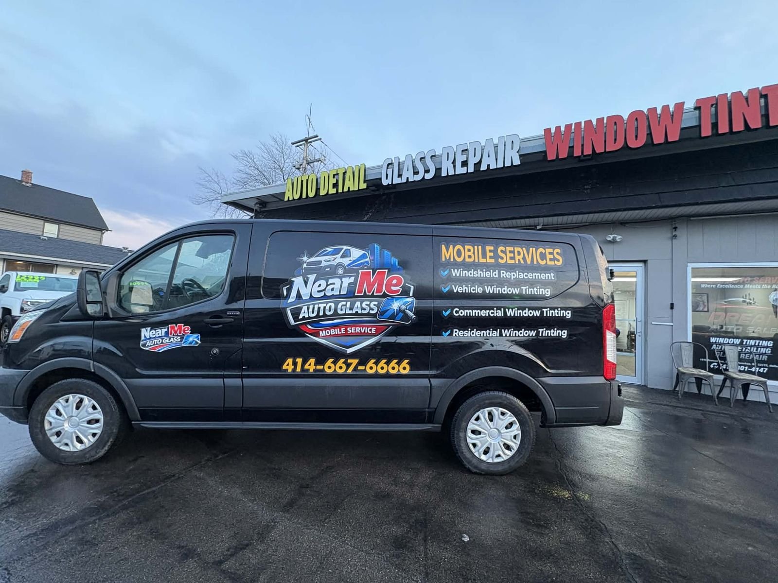 Near Me Auto Glass van parked at the shop